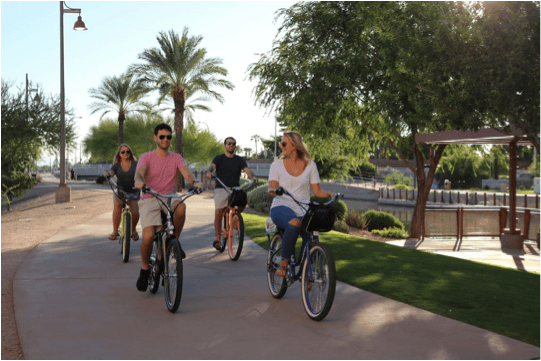 Friends riding Pedego electric bikes in Scottsdale|