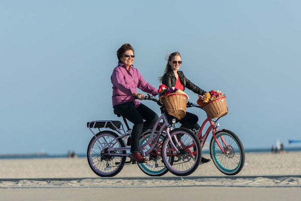 Mother and daugther riding Pedego electric bikes together|
