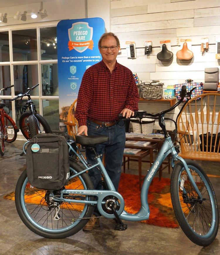 Steve Harvin, owner of Pedego Baton Rouge, standing with a Pedego bike.