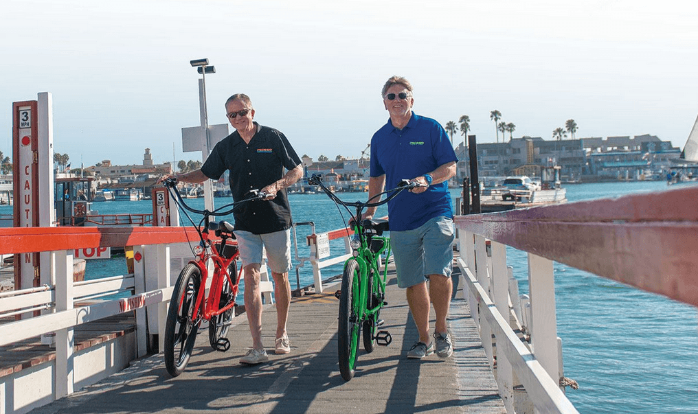 Pedego CEO and co-founder Don DiCostanzo (right) rides with CFO and co-founder Terry Sherry