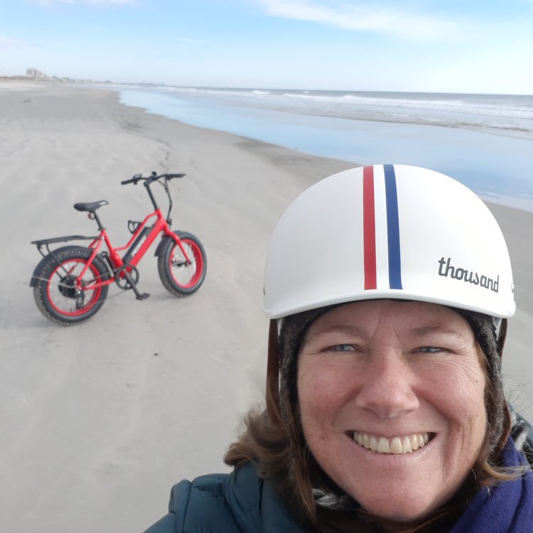 Pedego rider, Agnes Knoll, on the beach with her Element bike.