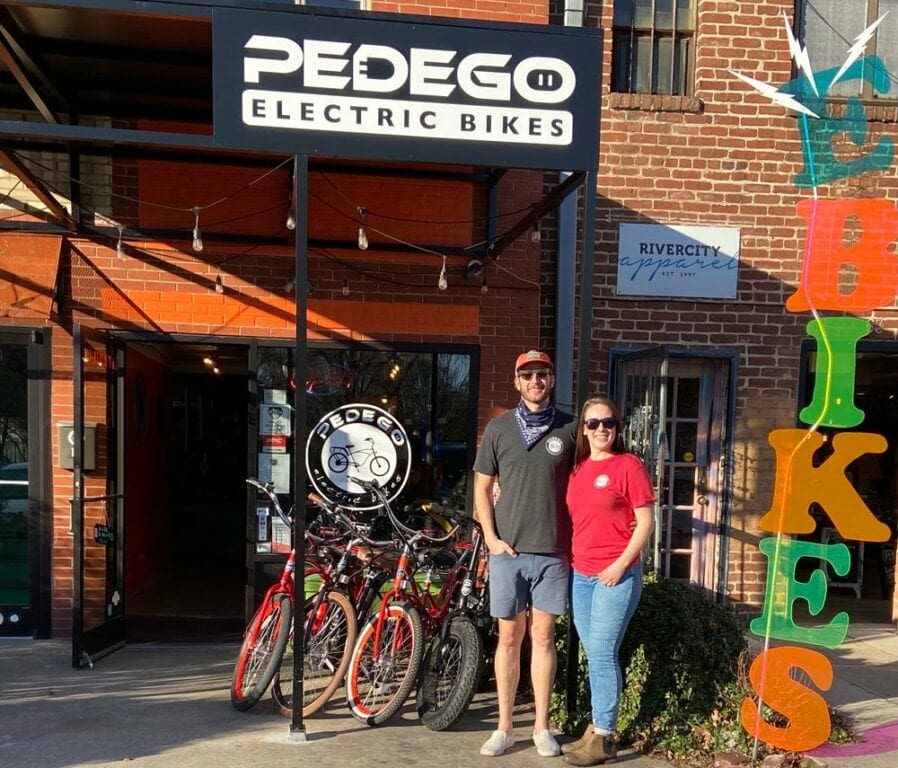 Adam and Kamrie, owners of Pedego Chattanooga, outside their storefront.