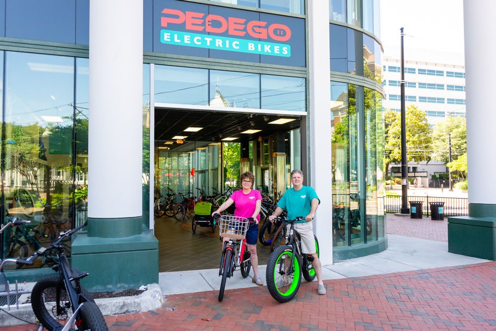 Amy and Kevin Oliver of Pedego Norfolk outside their storefront.
