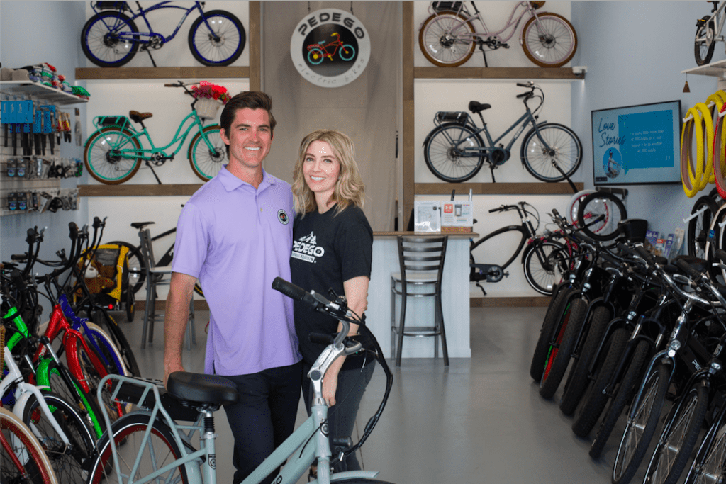 Owners of Pedego McDowell Mountain, Jon and Molly Krick, standing inside their store.