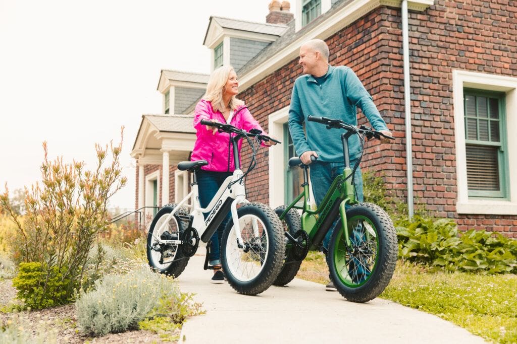 Couple getting ready to go on a ride on their Pedego Element electric bike