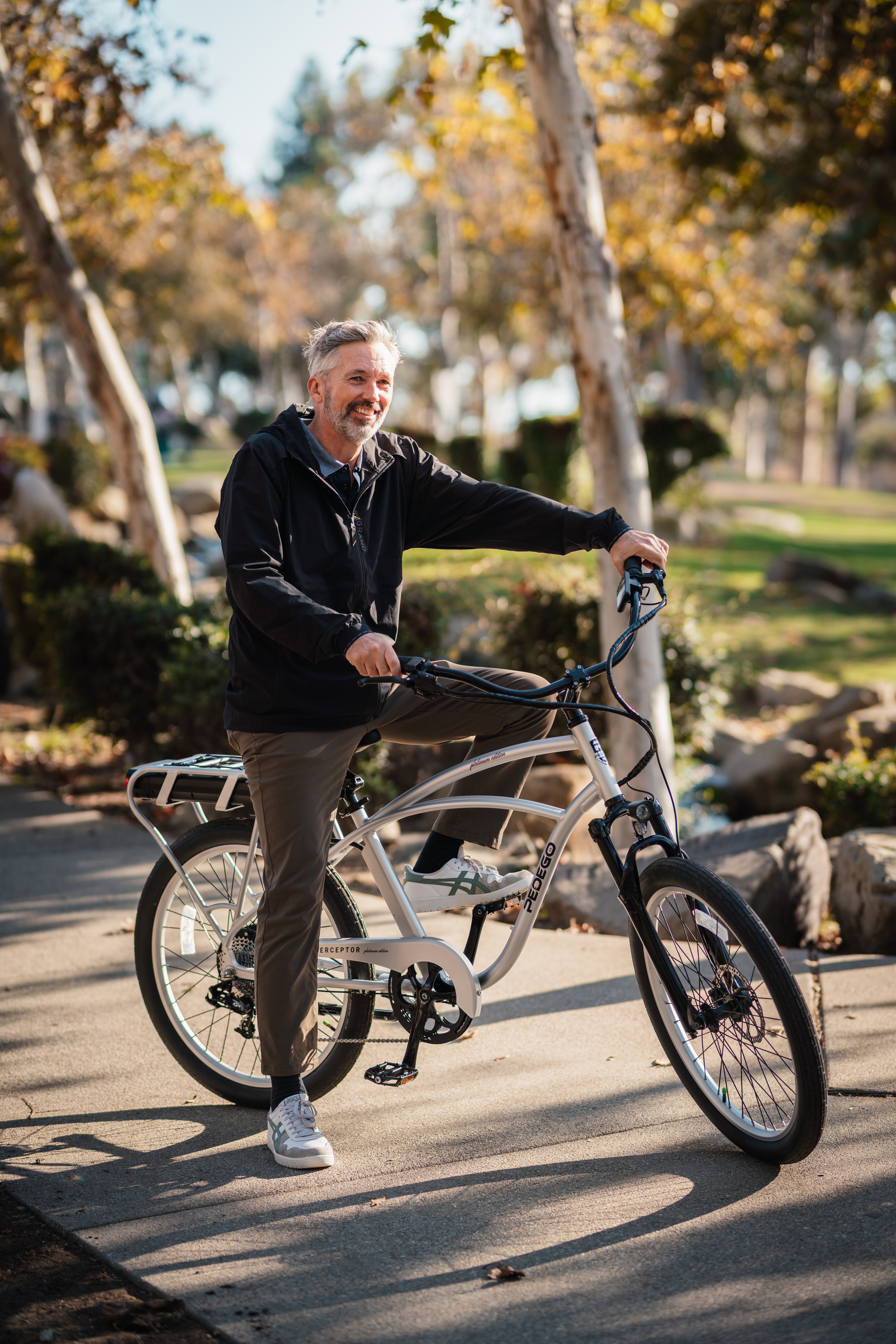 Man enjoying a ride in the park on his Pedego Interceptor electric bike